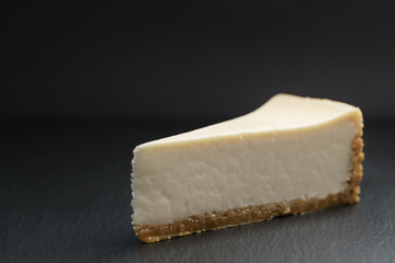 slice of new york cheesecake on slate board