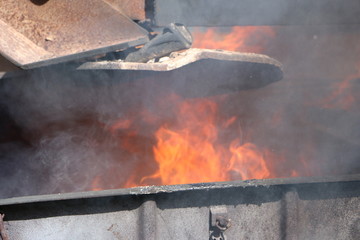 Iron metal structures covered with a bright flame of fire from containers