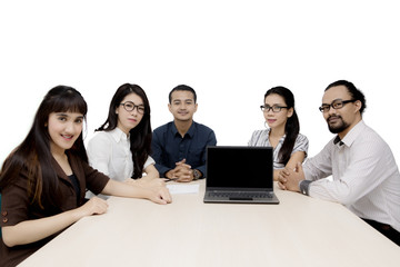 Fototapeta premium Multiracial employees with laptop on table