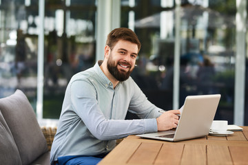 Fototapeta premium Smiling Bearded Man Working in Office
