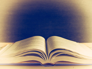 Open book on a black background. (Vintage colors picture).