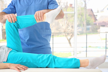 Physiotherapist working with patient in clinic