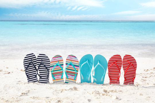 Colorful flip-flops on sea shore. Summer vacation concept