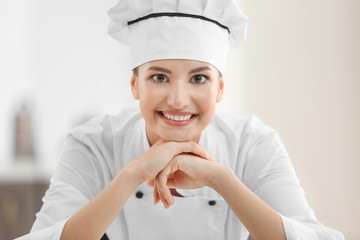 Young female chef in kitchen