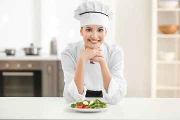 Young female chef in kitchen