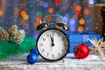 Retro alarm clock and decorations on table. Christmas countdown concept