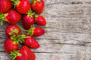 Ripe fresh strawberries on rustic wooden background with copy space. Top view