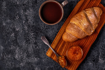 Fresh croissant on dark background.