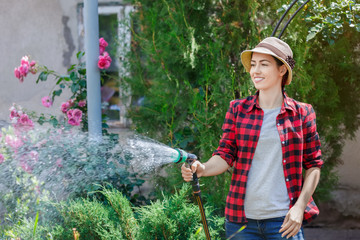 woman gardener watering garden