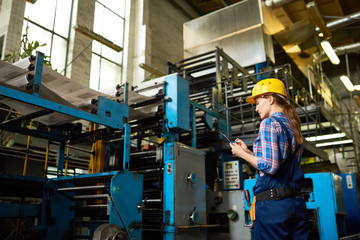 Female Factory Worker Overseeing Production