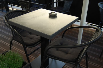 Table in a street cafe with two chairs