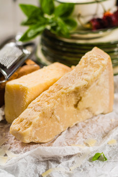 Aged parmesan cheese on the olive wooden board