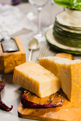 Aged parmesan cheese on the olive wooden board