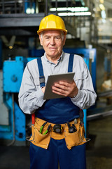 Senior Man Working at Modern Factory