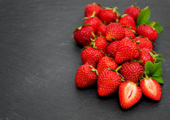 Strawberries on a black stone background