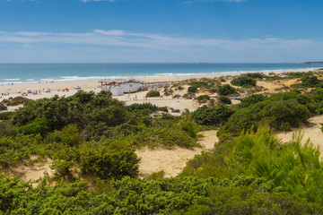 Sand dunes between hotels and beach of La Barrosa in Sancti Petri, Cadiz, Spain