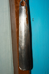 Old metal shoehorn hanging on the wall
