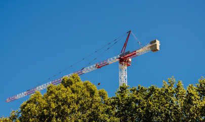 Gigant construction cranes against a blue sky