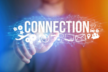 Concept of man holding a futuristic interface with connection title and multimedia icons flying all around - Internet concept