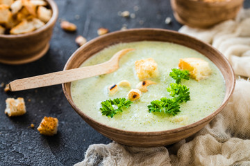 Green healthy cream soup with  broccoli, crackers, cashew, parsley