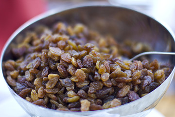 Brown dried grape at the silver cup