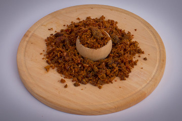 Homemade pork greaves in wooden bowl and on wooden plate