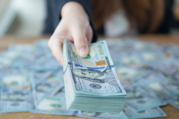 Hand on US Dollars (100 US Dollars) bank note