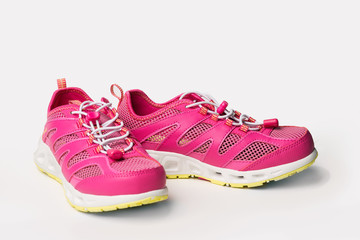 Pink sneakers on a light