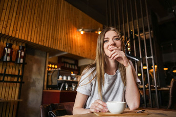 The girl in the cafe table with a cup of thought