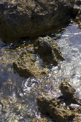 Fototapeta na wymiar Stones on the beach at the sea under water