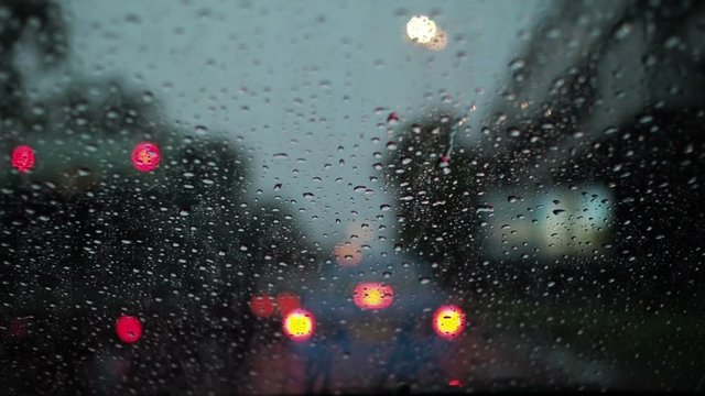 Raining in city while traffic jam in evening.