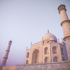 Fototapeta premium Amazing view on the Taj Mahal in sunset light with reflection in water. The Taj Mahal is an ivory-white marble mausoleum on the south bank of the Yamuna river. Agra, Uttar Pradesh, India.