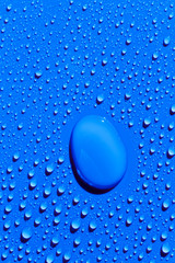 Water drops on surface, blue background