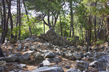 Ancient old ruins of the Lycian in Phaselis Aged stones at the pines forest