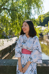 an asian young woman smiling and wearing Yukata