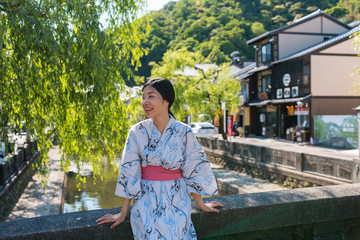 an asian young woman smiling and wearing Yukata