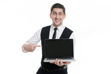 Businessman man with a laptop in hand in a white shirt . Displays in the monitor and smiling