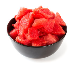 Pieces of ripe watermelon in a cup on a white background