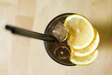 Cocktail on a wooden table. Mint, lime, ice ingredients, and bar table.