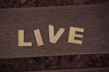 word live made with wooden letters. Wooden illustration blackground