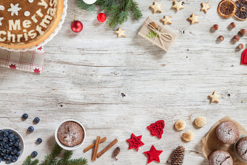 Christmas decorations. Set for greeting card: branch of fir tree, cones, walnuts, cookies, cinnamon, berries, dried orange, red christmas tree toys. Top view. View from above. Copy space.