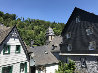 Fototapeta na wymiar Timberframe houses and a church in Monschau