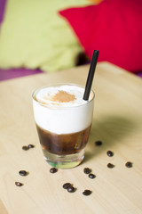 Cocktail on a wooden table. Coffee cocktail on a bar table.