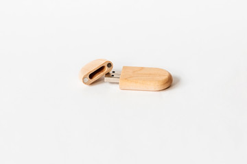 Light Wooden USB flash drive on a white isolated background. Copy space.