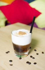 Cocktail on a wooden table. Coffee cocktail on a bar table.