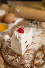 cheese cream cake topping with whipped cream and cherry. cake background concept
