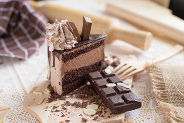 chocolate cake slice with chocolate cream and chocolate bar. cake background concept