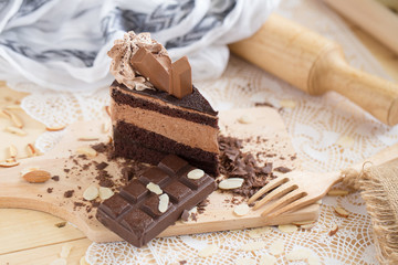 chocolate cake slice with chocolate cream and chocolate bar. cake background concept