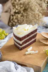 Obraz na płótnie Canvas chocolate cake and white chocolate on Wood plate. cake background concept