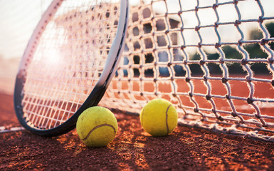 Tennis ball with racket on the tennis court. Sport, recreation concept